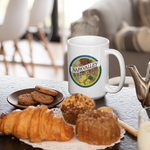 White mug with a label on a table with pastries and cookies