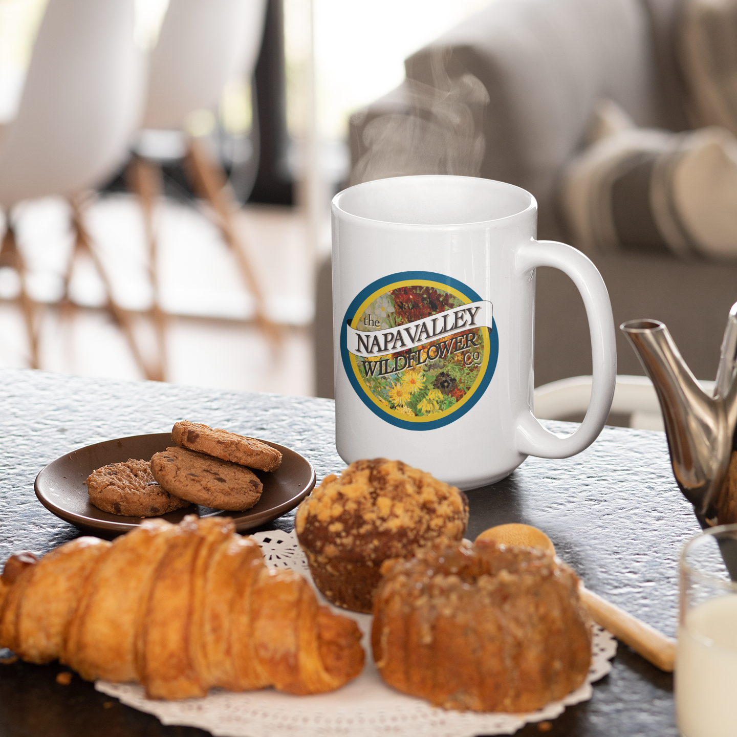 White mug with a label on a table with pastries and cookies