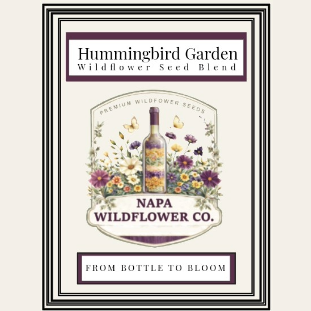A framed vintage-style label or package design for Hummingbird Garden Wildflower Seed Blend, featuring a central bottle surrounded by illustrated wildflowers and butterflies, with the text 'NAPA WILDFLOWER CO.' and 'FROM BOTTLE TO BLOOM' on a cream background.