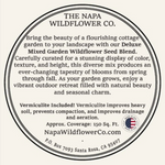 A circular printed label or package insert for The Napa Wildflower Co. Deluxe Mixed Garden Wildflower Seed Blend, with black text on a warm cream background and a small American flag seal near the lower right.