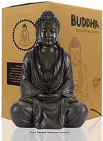 Buddha meditating statue with packaging in the background