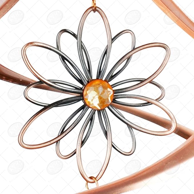Decorative metal flower with a central orange gem on a white background