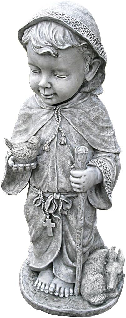 Statue of a child in religious attire holding a dove and a cross.