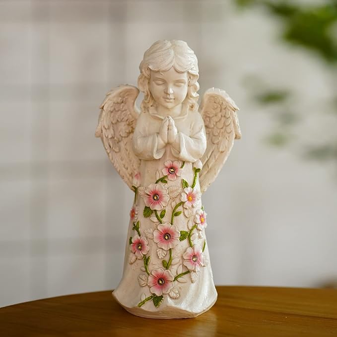 Decorative angel figurine with floral design on a wooden surface