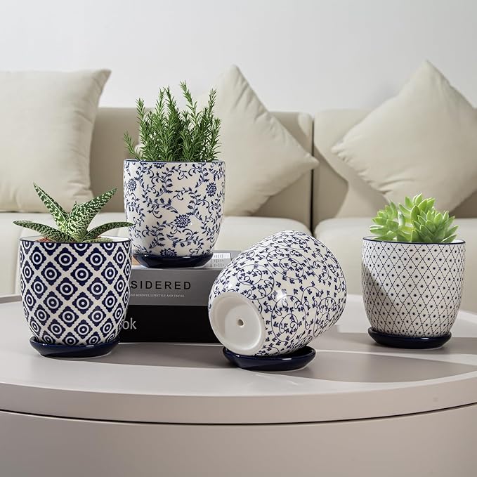 Decorative potted plants with patterned pots on a coffee table.