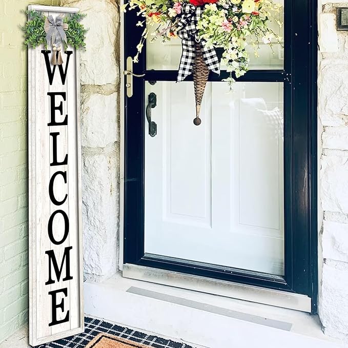 Decorative 'WELCOME' sign on a door with floral decorations.