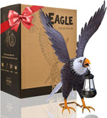 Solar eagle statue with open wings next to its packaging box.