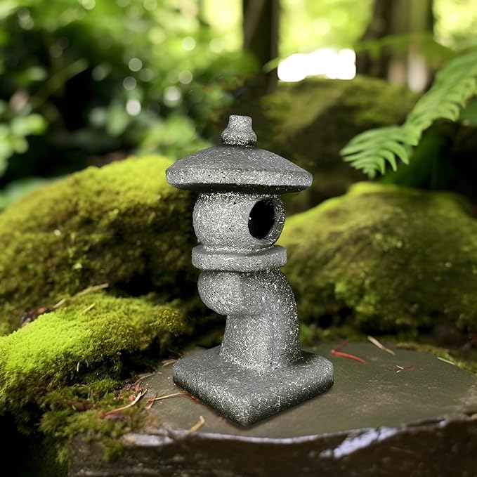 Stone lantern on a mossy stone in a forest setting