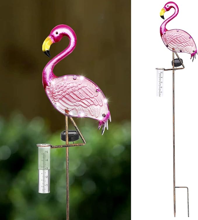 Pink flamingo garden stake with solar light on a blurred green background