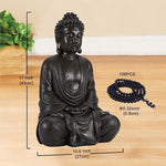Buddha statue with measurements and a string of beads on a wooden surface