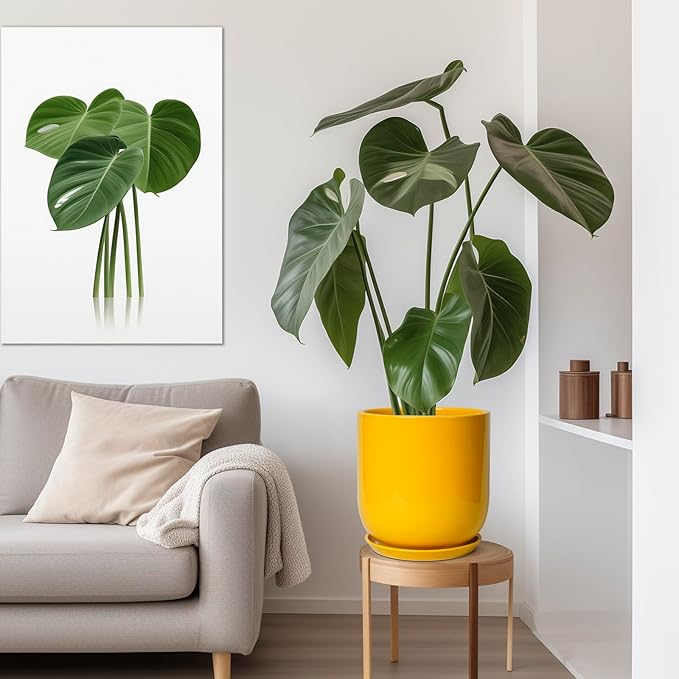 Living room with a gray sofa, yellow pot with a green plant, and a framed plant picture on the wall.
