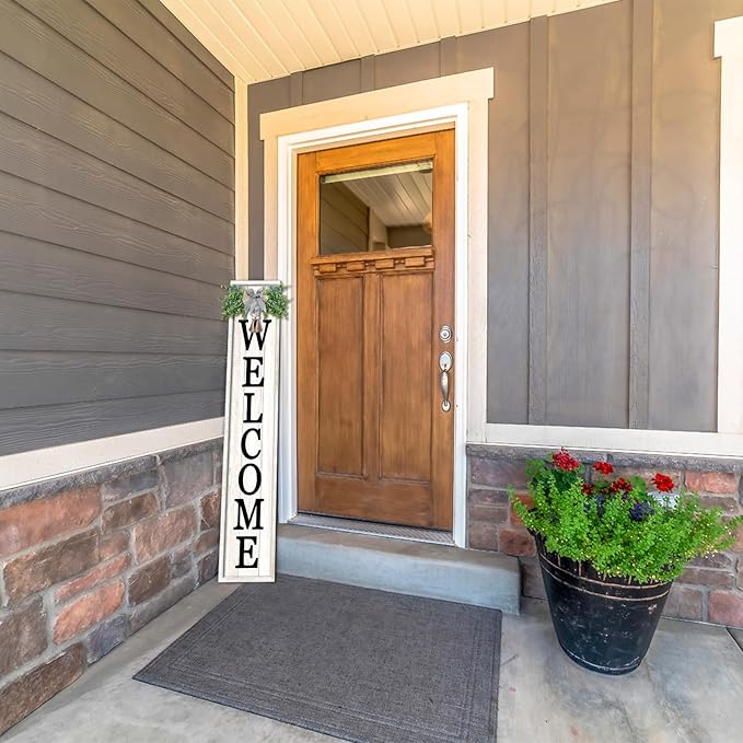 Front door of a house with a 'Welcome' sign and potted plant