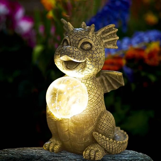 Dragon-shaped solar light with glowing ball on a dark background