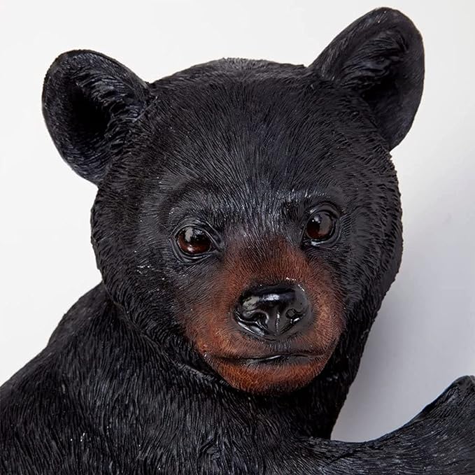 Close-up of a black bear figurine against a white background
