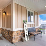 Front porch with a bench, decorative mirror, and 'WELCOME' sign on a wooden house.