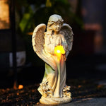 Statue of an angel holding a light source with a blurred background
