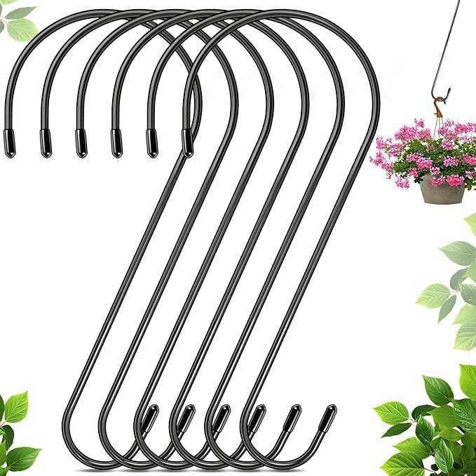 Set of black metal hooks with a plant in the background
