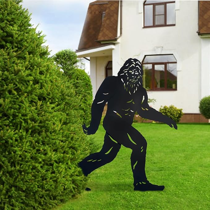 Black silhouette of a creature on a grassy lawn in front of a house