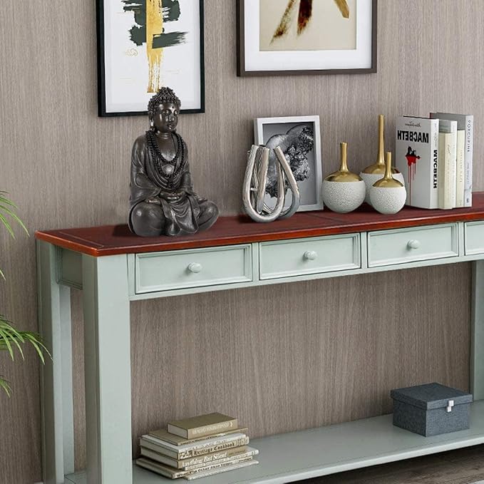 Console table with decorative items against a wall with framed art.