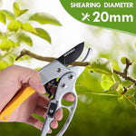 Hand holding a pair of gardening shears with a branch and green leaves in the background, labeled 'Shearing Diameter 20mm'.