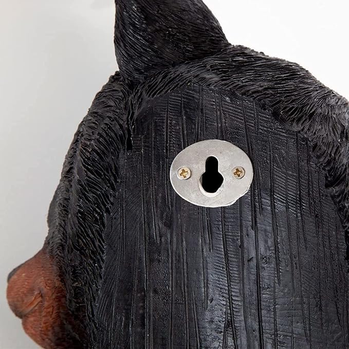 Close-up of a black dog figurine with a metallic keyhole on a white background