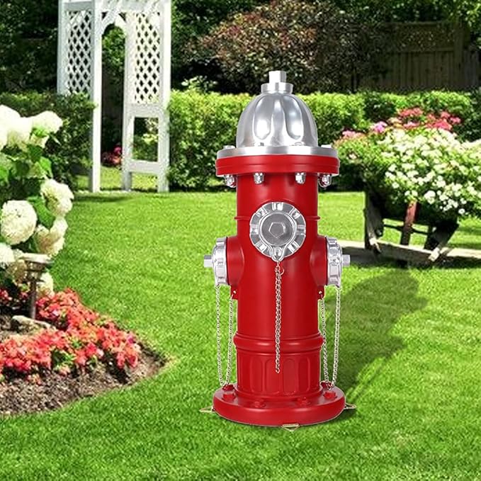 Red fire hydrant with silver details on a grassy lawn
