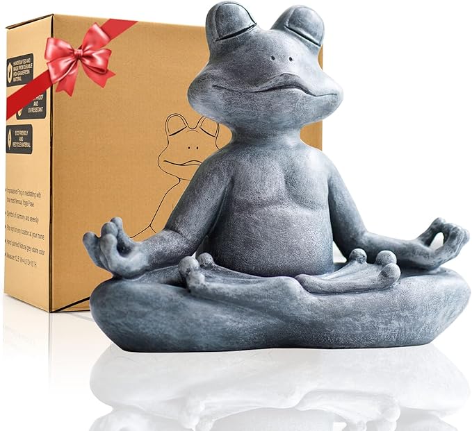 Gray frog statue in meditating pose with a gift box in the background