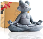 Gray frog statue in meditating pose with a gift box in the background