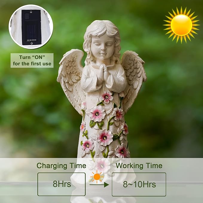 Decorative angel statue with floral details and solar panel, set against a natural background.