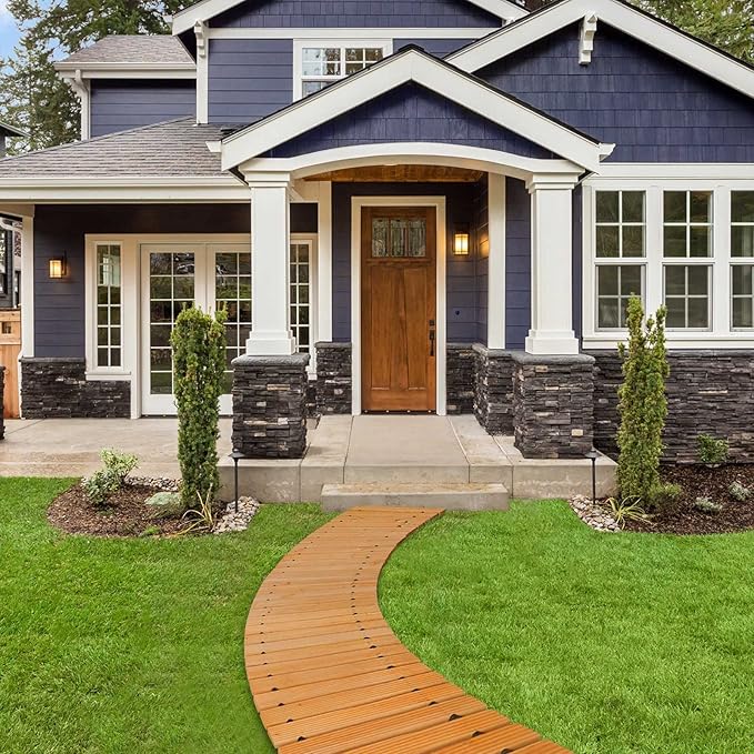 Blue house with a wooden pathway leading to the front door