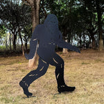 Metallic Bigfoot silhouette in a forest setting