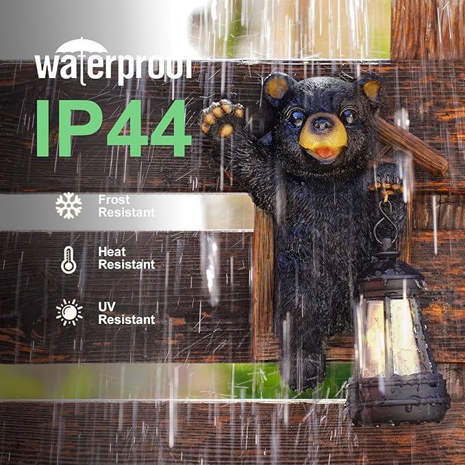 Black bear figurine with lantern in rain, featuring waterproof IP44 rating.