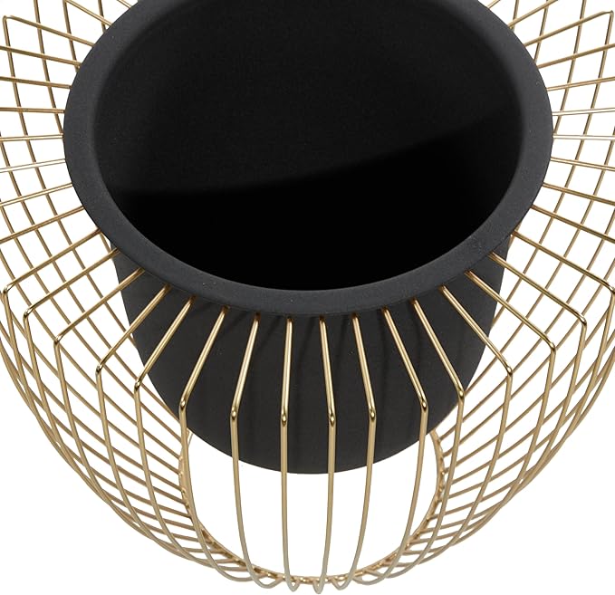 Black pot on a gold wire stand against a white background