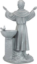Statue of a religious figure with outstretched arms next to a bird bath on a white background