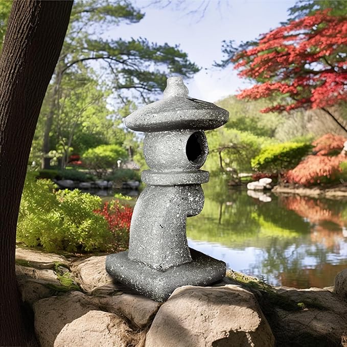 Stone lantern in a garden setting with a pond and trees