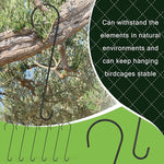 Metal birdcage hook hanging from a tree branch with text about durability.