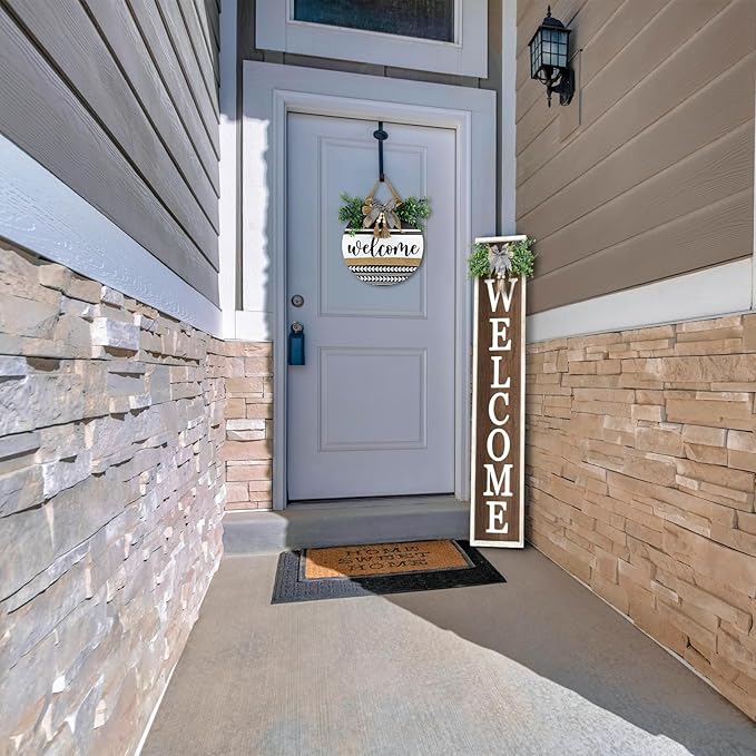 Front door of a house with a welcome sign and doormat.