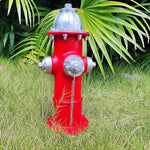 Red fire hydrant with silver components on grass