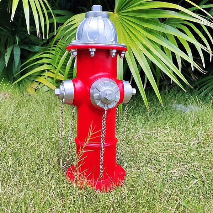 Red fire hydrant with silver components on grass