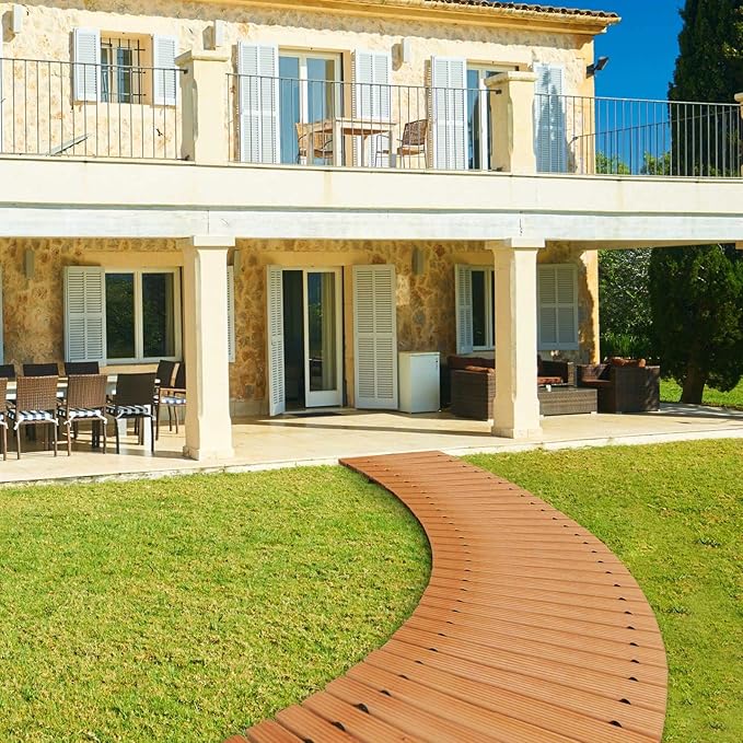 Stylish outdoor patio area with a wooden pathway leading to a house.