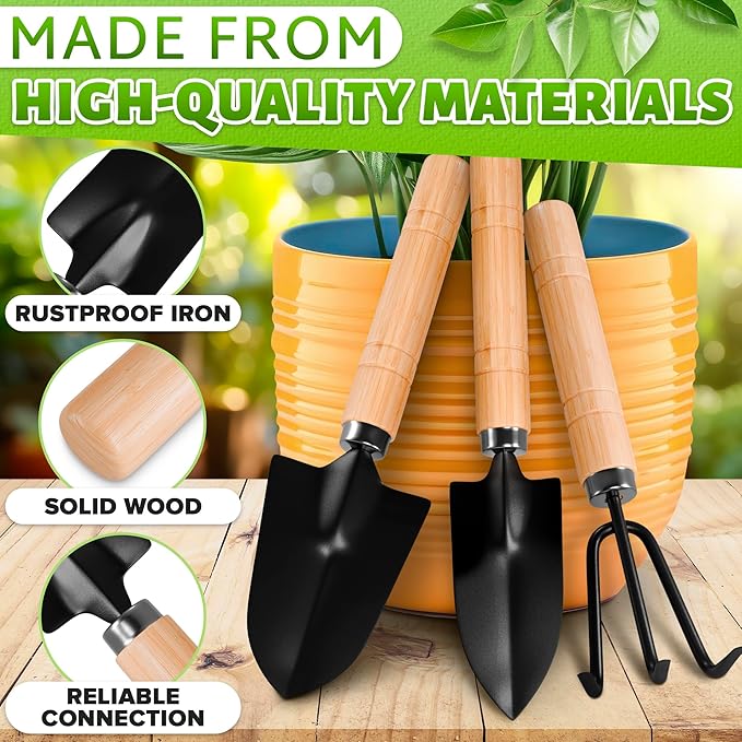 Gardening tools with wooden handles and black metal heads, placed against a blurred green garden background.
