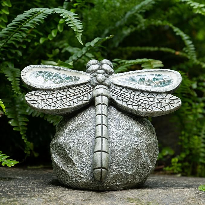 Decorative stone dragonfly sculpture on a natural background