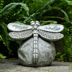Decorative stone dragonfly sculpture on a natural background