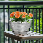Potted plant with orange flowers on a wooden table outdoors