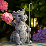 Dragon figurine holding a lantern with flowers in the background