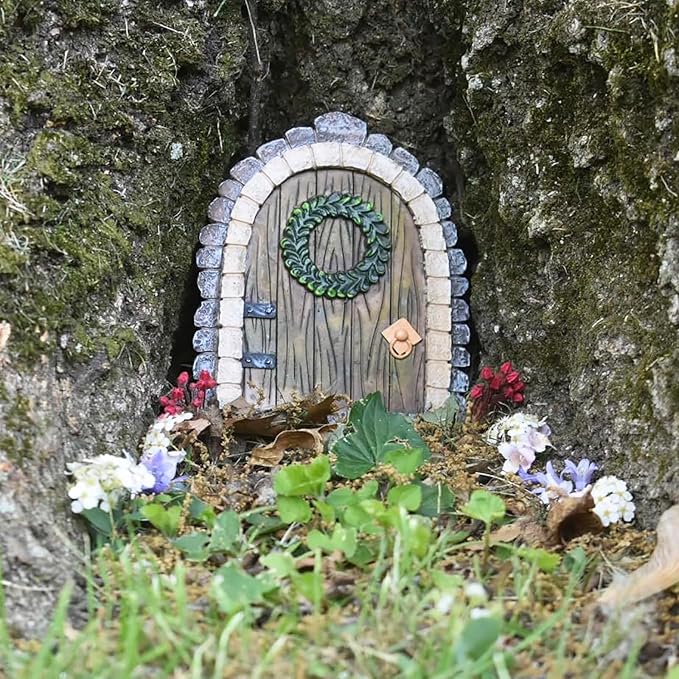 Fairy door embedded in a tree trunk with decorative elements.