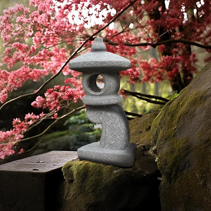 Stone lantern on a rock with cherry blossoms in the background