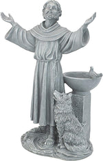 Statue of a religious figure with outstretched arms and a dog beside a bowl on a white background