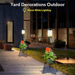 Yard decorations with warm white lighting on a wooden deck and grass area.