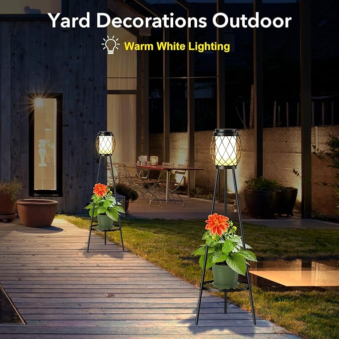 Yard decorations with warm white lighting on a wooden deck and grass area.